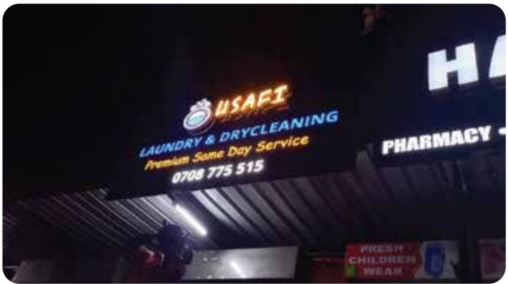 Lit shopfront row — Usafi Laundry & Drycleaning